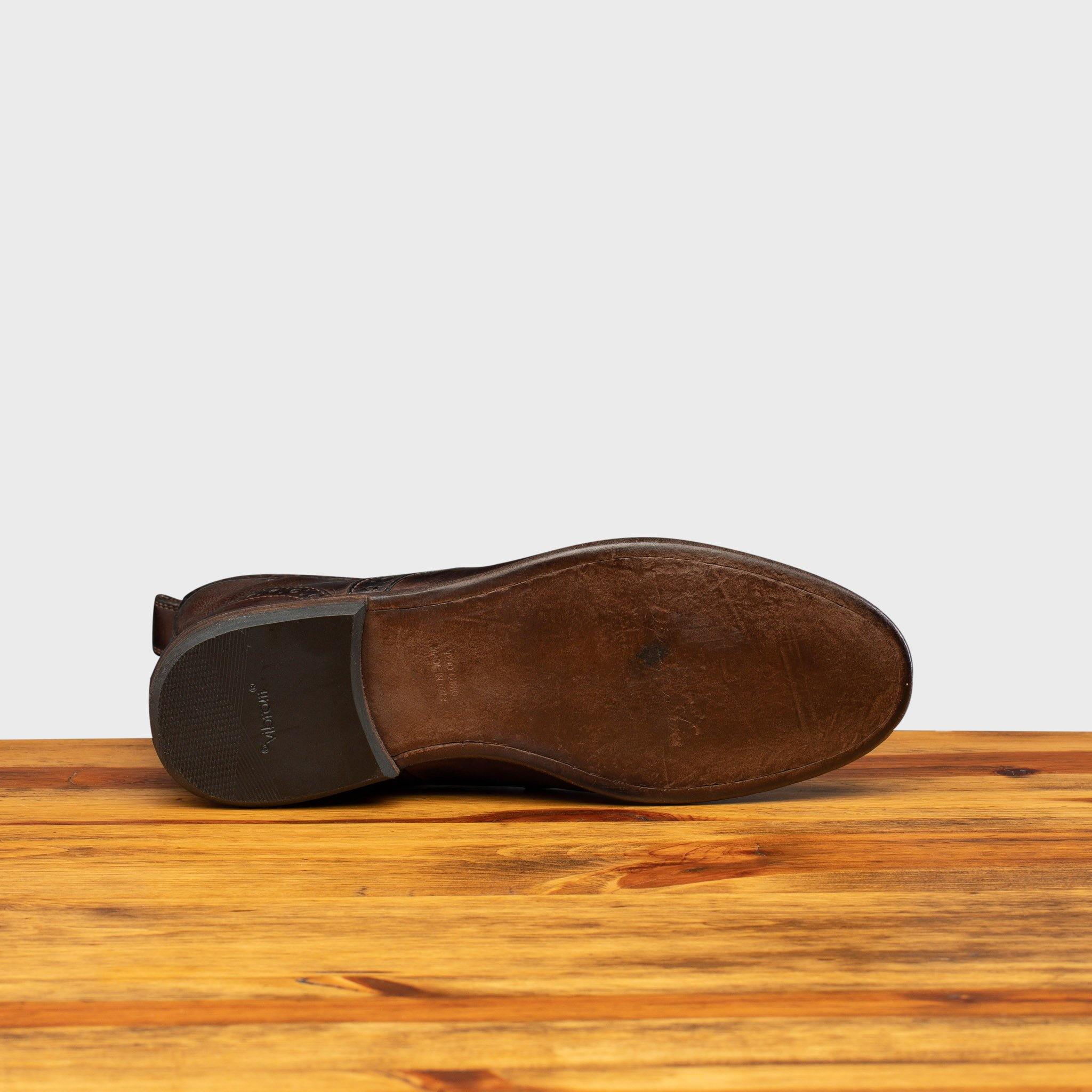 Full leather outsole with vibram rubber heel of 7149 Calzoleria Toscana Women's Brown Dip-Dyed Diver Combat Boot on top of a wooden table